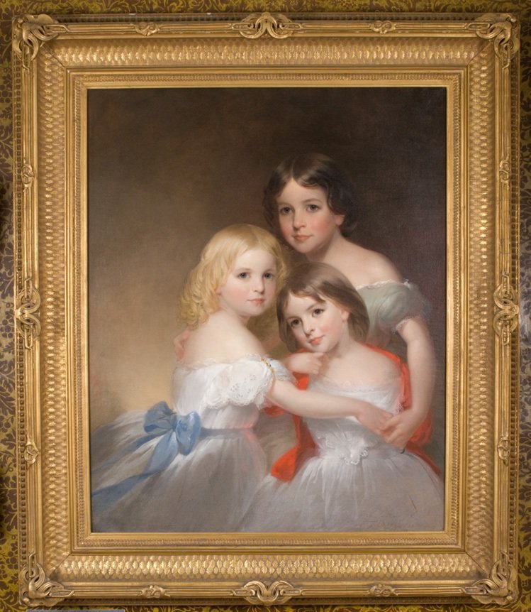 Oil on Canvas portrait of three young girls finished in a golden frame.